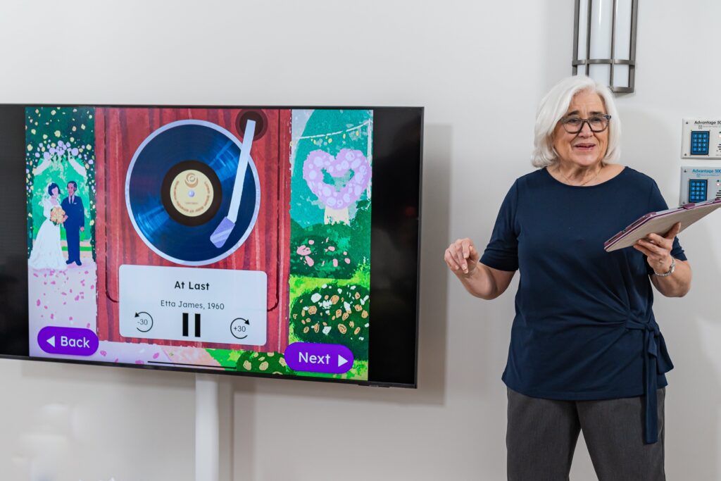 A volunteer leading a Making Connections Through Music session